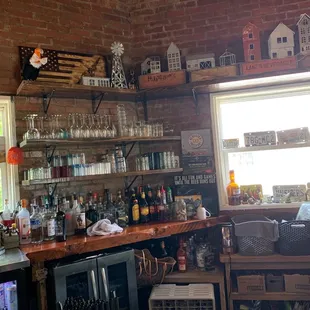 a brick wall with shelves of bottles