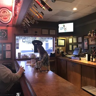 a man and a dog sitting at the bar