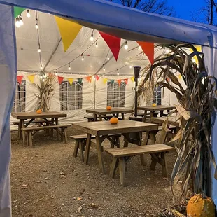 tables and chairs under a tent