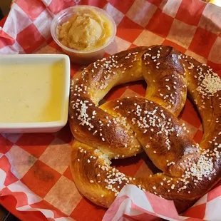 Warm Soft Pretzel with provolone cheese sauce and sweet honey butter.