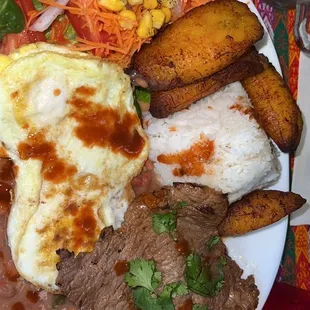 Rice, fried egg, steak, plantains, and beans.