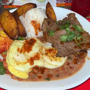 Rice, beans, steak, fried egg, and plantains