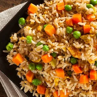 vegetable chaufa fried rice served with plantains or egg roll and green hot sauce/aji.