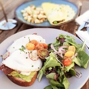 Avocado toast with two eggs (over-easy) and side of salad.