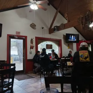 people sitting at tables in a restaurant