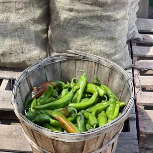a basket full of green peppers
