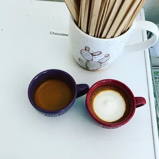 two cups of coffee and a spoon