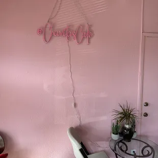 a pink wall with a sign that says chavita&apos;s cafe
