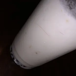 a glass of milk on a table