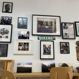 a wall full of framed photographs