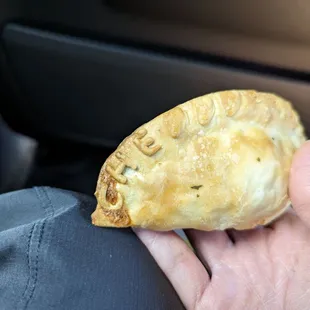 a hand holding a pastry