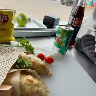 a bag of chips, tomatoes, and a bag of chips on a table
