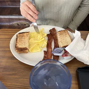 Scrambled eggs, toast and bacon.