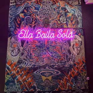 a neon sign that says ela balla sol
