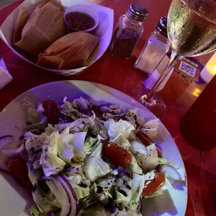 Green salad, tamales, and white wine