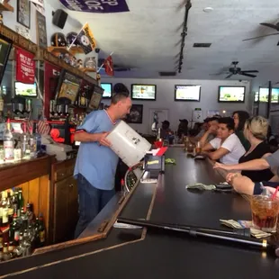 a bartender pouring a drink