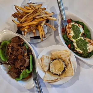 On the left is a stuffed green pepper and on the right is the pesto chicken (mine).  Rounding out these are fries and pita with hummus.