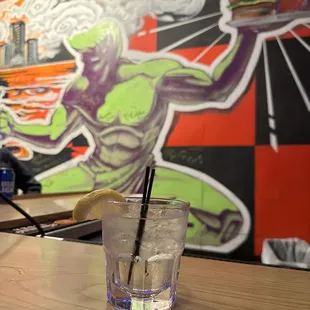 a glass of water with a straw in it