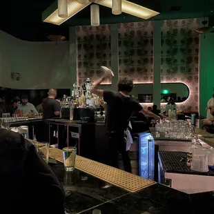 a bar with people sitting at the bar