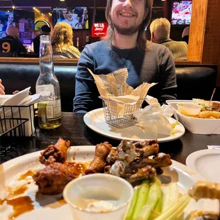 a man sitting at a table with a plate of food
