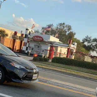 a black car and a silver car on the road