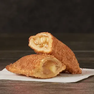 a close up of a fried donut with a bite taken out of it
