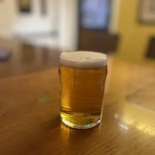 a glass of beer on a table