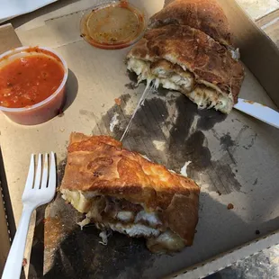a half eaten sandwich and a fork