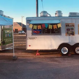 a food truck with people standing outside