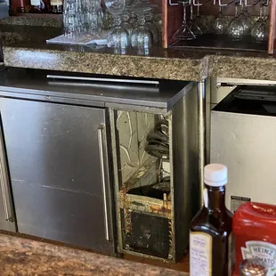 a kitchen counter with a wine cooler