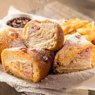 Monte Cristo: Smoked ham, smoked turkey, 2 cheeses, battered &amp; fried until golden w/raspberry preserves &amp; dusted w/powdered sugar, w/fries