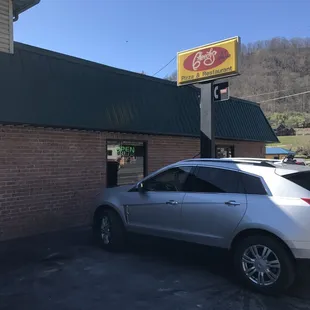 a car parked in front of a restaurant