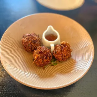 Coconut Prawn Croquettes: baby prawn &amp; potato croquette, coated in coconut, served with mirchi pani (a light, spicy sauce)