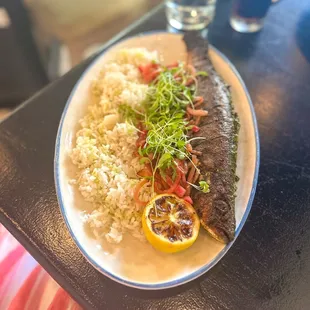 Hariyali Whole Fish: whole branzino rubbed with paste of ginger, herbs, and green chiles before being skewered and cooked in the tandoor