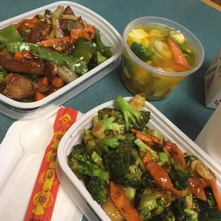 Bean curd Szechuan style, vegetable with bean curd soup, broccoli with garlic sauce. And chopsticks.