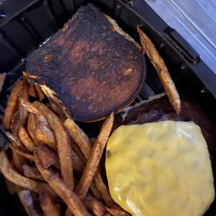 Burnt burger under the cheese with a burnt burnt
