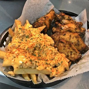 Jerk Wings &amp; Crab Fries topped with our famous housemade Cheers Sauce