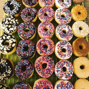 a variety of donuts on a cooling rack