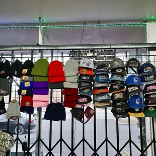 a rack of caps and hats