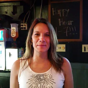 a woman standing in front of a neon sign