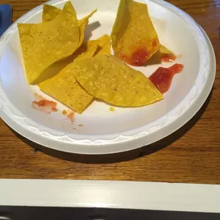 a plate of nachos and ketchup