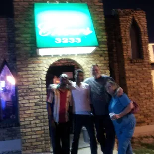 a group of people standing in front of a business