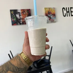 a hand holding a cup of coffee