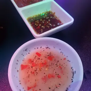 a bowl of soup and a bowl of dipping sauce