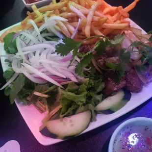 a plate of salad and french fries
