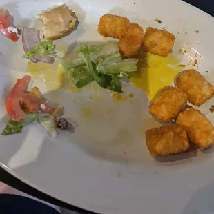 The aftermath of a smoke pork quesadilla and a loaded burger. Let&apos;s just say best Tater Tots in the world crispy hot and lightly salted.