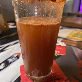 a glass of beer on a coaster