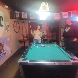 a woman playing pool