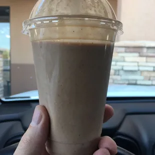 a hand holding a cup of coffee