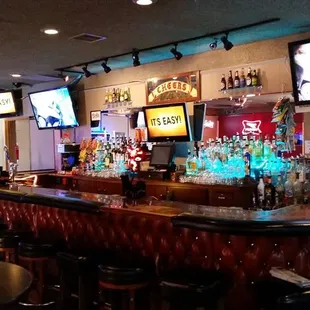 a bar with several televisions on the wall